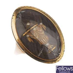An oval memorial ring with hair design set within