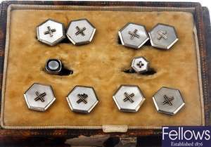 A box containing five silver dress studs with a