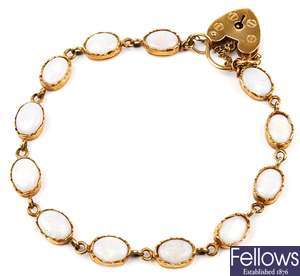 A 9ct gold opal bracelet, set with twelve opals