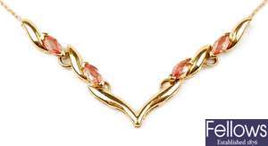 An 18ct gold orange sapphire set necklace, with a