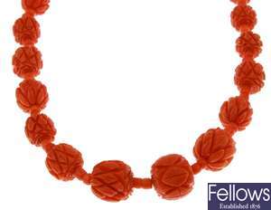 A carved graduated coral bead necklace, with