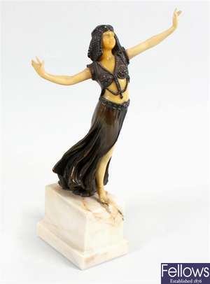 A reproduction bronze and faux ivory figurine