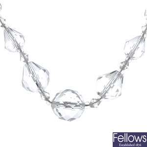 A graduated faceted clear plastic bead necklace.