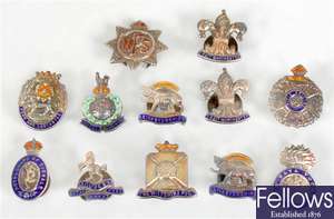 Twelve silver and enamelled lapel badges