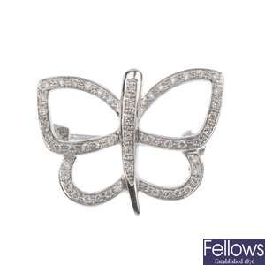 A diamond butterfly pendant with brooch fitting.