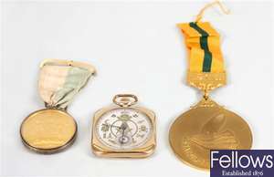 A gold plated crown wind pocket watch, a selection of Masonic medals and dress swords, walking canes