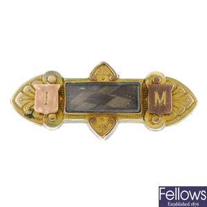 Three brooches and a nurses buckle.