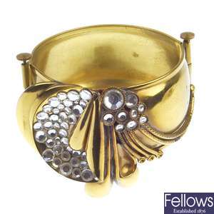 A large hinged bangle with applied decoration and paste stones and matching necklet.