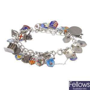 Eight silver and white metal charm bracelets.