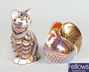 A Royal Crown Derby bone china ornament modelled as a cat and a similar cockerel