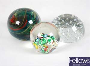An Isle of Wight glass paperweight with internal coloured glass and other paperweights