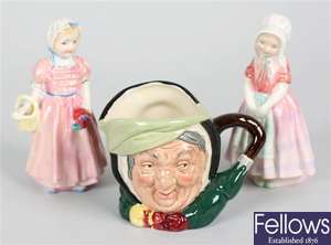 Two small Royal Doulton bone china figurines and a Royal Doulton character mug
