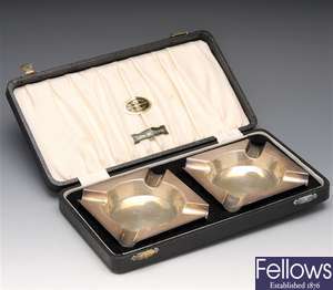 Cased pair of silver ashtrays.