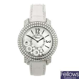 An 18k white gold quartz Chopard Happy Diamond wrist watch.
