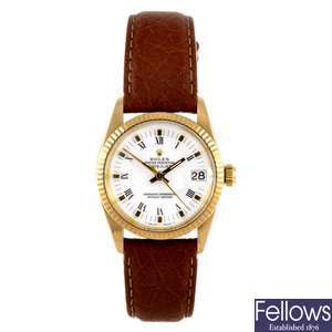 An 18k gold mid-size Rolex Datejust wrist watch.