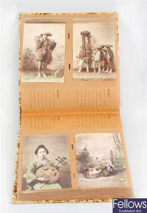 A 20th century oriental silk covered postcard album