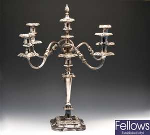 A silver-plated four-branch candelabrum, a pair of matching candlesticks, three glass vases, etc.