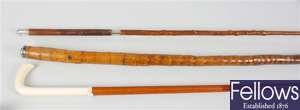 A 19th century walking cane with shaped ivory walking cane