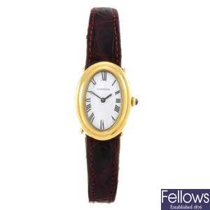 An 18k gold manual wind lady's Cartier Baignoire wrist watch.