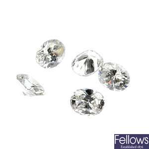 A quantity of loose oval-shape diamonds.