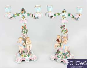 A pair of early 20th century German porcelain two branch candelabra
