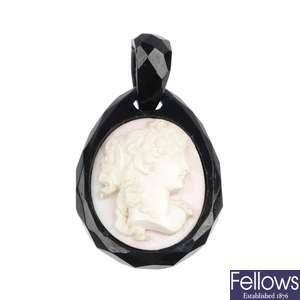 A jet and conch shell cameo pendant. 