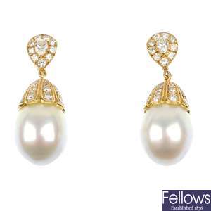 A pair of cultured pearl and diamond ear pendants.