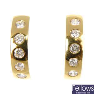 A pair of 18ct gold diamond half-hoop earrings. 