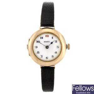 A 9ct gold manual wind lady's trench style Rolex wrist watch.
