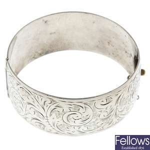 Four hinged silver bangles.