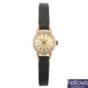 An 18k gold manual wind lady's Omega wrist watch.