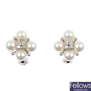 A pair of continental cultured pearl and diamond ear studs.