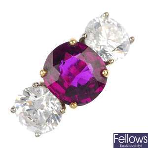 (528324-2-A) An 18ct gold diamond and ruby three-stone ring.