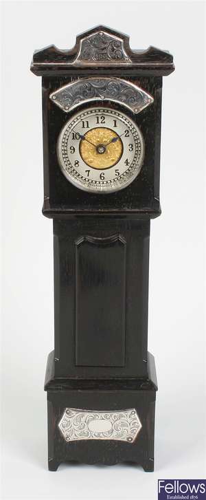 An Edwardian silver-mounted ebony miniature longcase clock