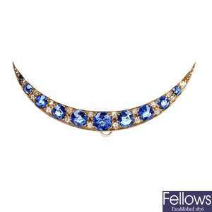 An early 20th century gold sapphire and diamond crescent brooch.