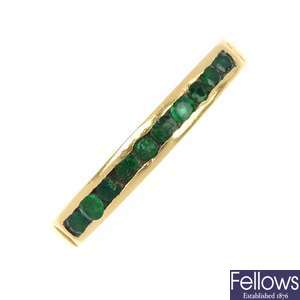 An 18ct gold emerald half-circle eternity ring.