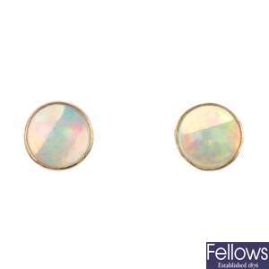 A pair of circular opal cabochon ear studs.