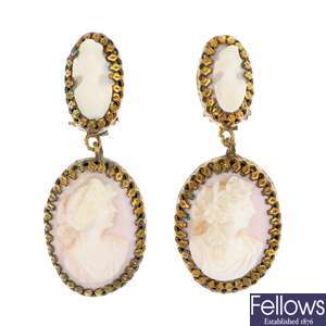 A pair of conch shell cameo ear pendants.