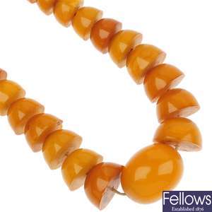 Two reconstituted amber necklaces and a selection of loose beads.