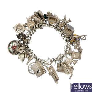 A selection of silver items to include a charm bracelet and a hinged bangle.