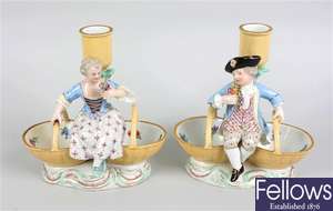 A pair of Meissen porcelain figural candlesticks