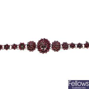 A late 19th century garnet bracelet and two rings.