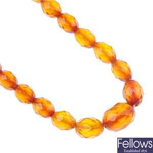 An amber bead necklace and a selection of loose beads.