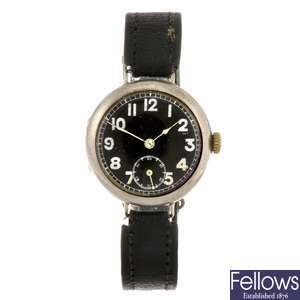 A silver manual wind gentleman's trench style wrist watch.