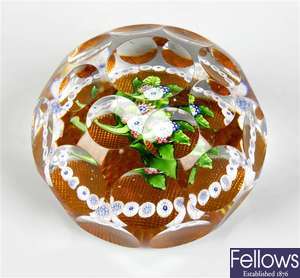 A facetted glass millefiori paperweight