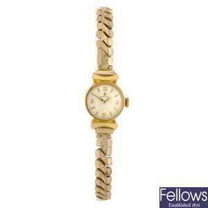 A gold plated manual wind lady's Omega bracelet watch with a Omega watch head.