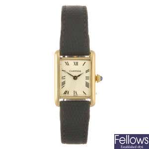 An 18k gold Cartier Tank wrist watch.