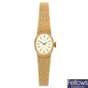 A 9ct gold manual wind lady's Tissot bracelet watch.