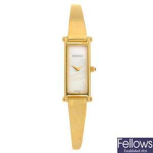 A gold plated quartz lady's Gucci bangle watch.