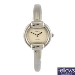 A stainless steel quartz lady's Gucci 1400L bangle watch.
